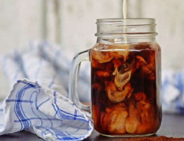 bir buzlu kahve içine süt dökün