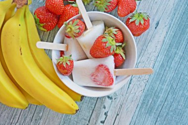 Süt, muz ve çilek ile ev yapımı buzlu şekerler 