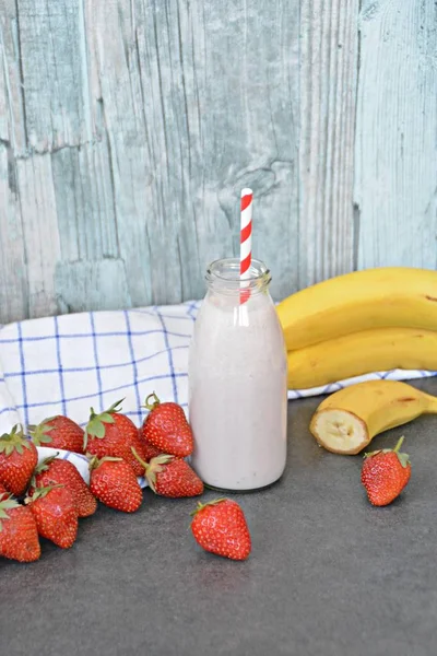 Homemade milk shake with strawberries and bananas as a perfect refreshment in summer