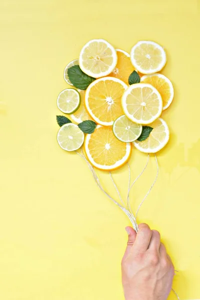 Close Man Holds Cords Hand Slices Lemons Limes Oranges Hanging — Stock Photo, Image