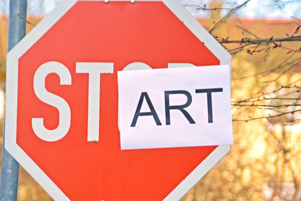 In the case of a stop sign, a part of the letters was pasted over and thus the term start read - concept with the background that every end is the chance for a new start