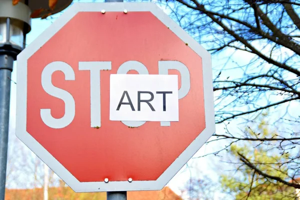 In the case of a stop sign, a part of the letters was pasted over and thus the term start read - concept with the background that every end is the chance for a new start