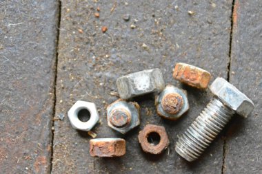 Çeşitli vidalar arkasında pozlama ile ahşap bir tezgah üzerinde yatıyor 