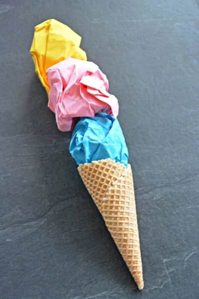 Ice Paper - Crumpled paper in the form of ice cream balls in an ice cream cone against a plain background