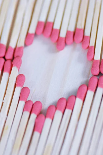 The head of many matches forms the shape of a heart - close-up