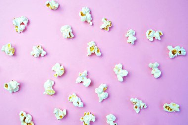 Patlamış mısır, yüzeyde birbirlerinden belirli bir mesafeden yatan patlamış mısır oluşan bir arka plan ile renkli bir yüzey-konsept üzerinde eşit olarak dağıtılır yatıyor 