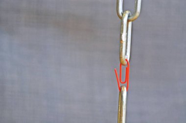 Kırmızı ataç iki çelik zincir birlikte biter tutar-zincirin zayıf noktası normal bir zincir bir ataç tarafından temsil-konsept ekip çalışması için soyut resimli