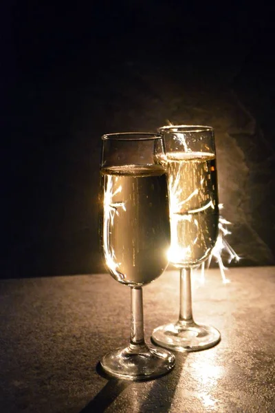 Two Filled Champagne Flutes Stand Dark Front Sparkler Which Illuminates — Stock Photo, Image