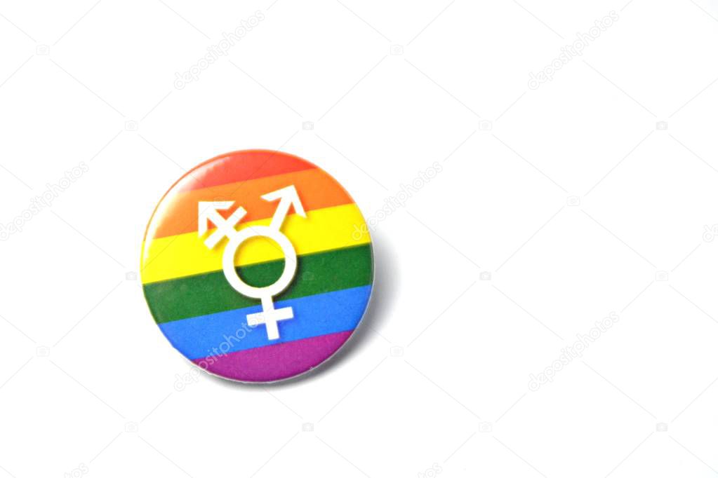 A button with the sign for transsexuality lies on a white background