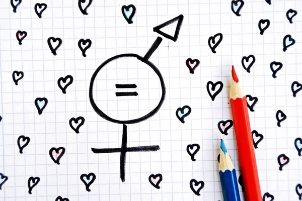 A sign for the equality of man and woman consisting of the respective gender signs and a same with partly painted hearts on a drawn sheet drawn - equality man and woman symbolically represented