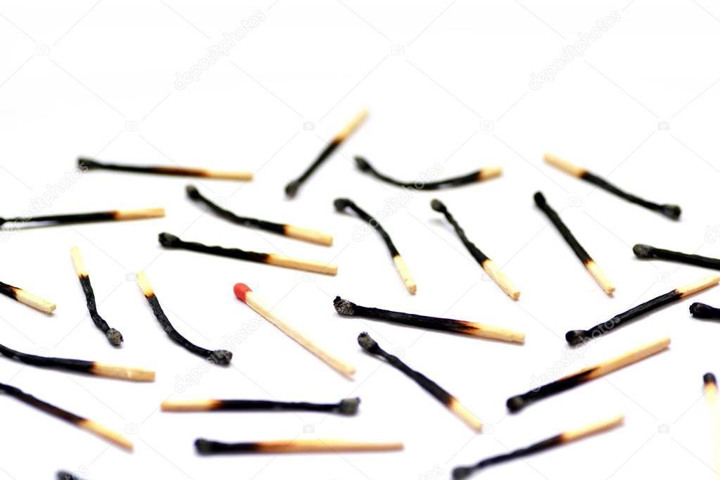 closeup view of many burnt matches over white background