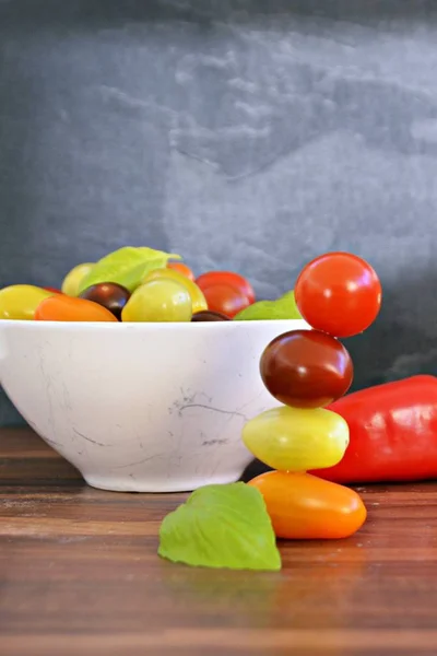 Different types of tomatoes in different colors and basil - concept with fresh and healthy different tomatoes, with space for text for other elements