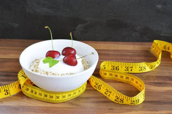 White Bowl Full Oatmeal Dollop Yoghurt Cherries Fruit Next Lying — Stock Photo, Image