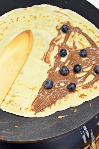 Homemade crepes in closeup with topics on a crepe iron - Fresh and delicious crepes homemade at home