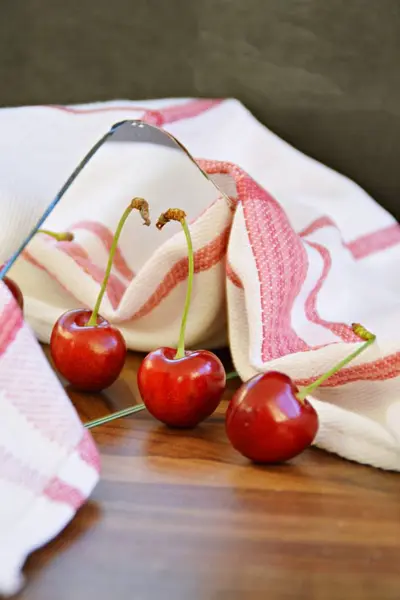 ripe red cherries on wooden table