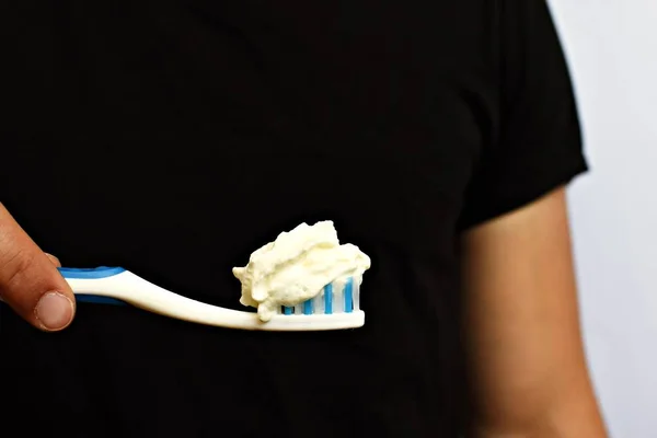 Man Holds Toothbrush Front His Torso Instead Toothpaste Cream Brushes — Stock Photo, Image