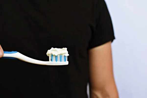 Man Holds Toothbrush Front His Torso Instead Toothpaste Cream Brushes — Stock Photo, Image