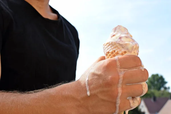 一个男人的上半身的特写 他手里拿着华夫饼冰淇淋 冰淇淋球野生浆果已经融化 由于热 太热的夏天与清爽的冷却 — 图库照片