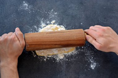 man's hand with wooden spoon