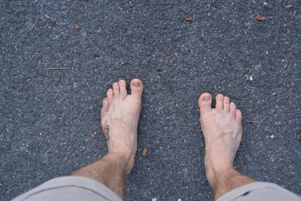 man's feet on the ground