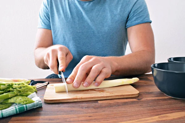 man cooking a cutting board.