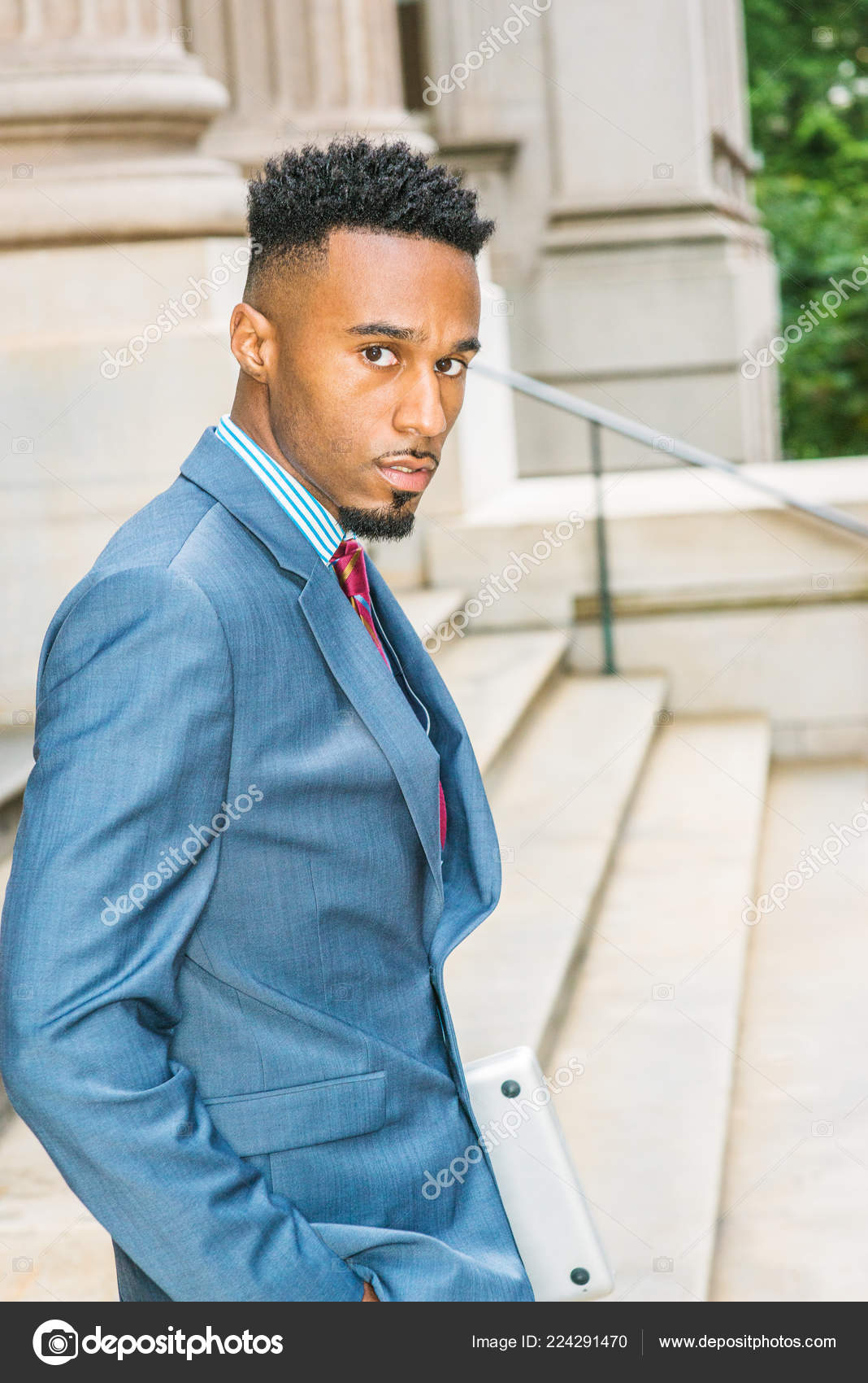 African American Businessman works in New York. Wearing blue suit