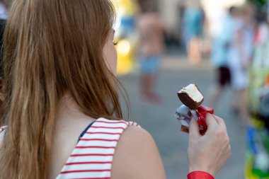 Dondurma elinde olan kadın. Arkadan görüntülemek.