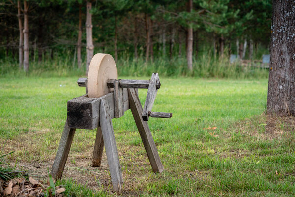 Historical tools. An old, hand-operated, sharpening tool - a grindstone.