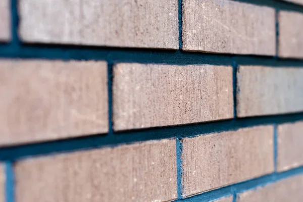 Selective focus close up photograph. Wall from red brick side view.