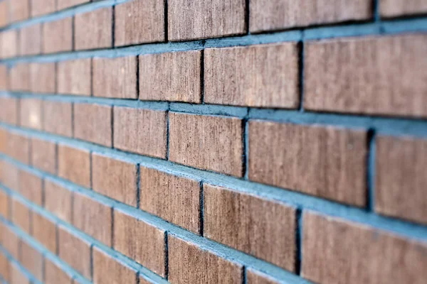 Selective focus close up photograph. Wall from red brick side view.