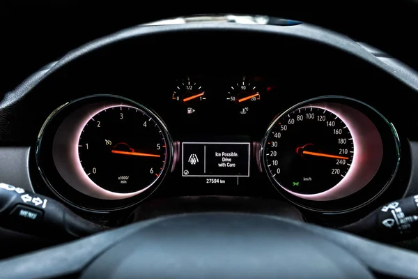 Car front instrument panel with warning of slippery roads.