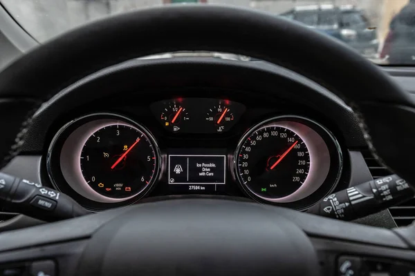 Car front instrument panel with warning of slippery roads.