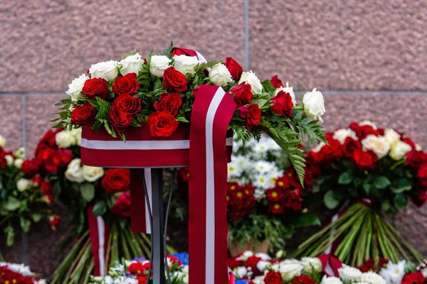 Flower bouquet with Latvian flag. Latvian Independence Day - image