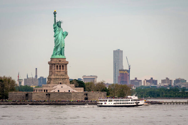 New York, USA - June 7, 2019: Ferry Boat approaching the Statue of Liberty, Liberty Island - Image