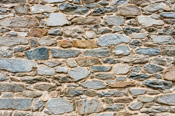 Old, different colors stone wall background texture close up