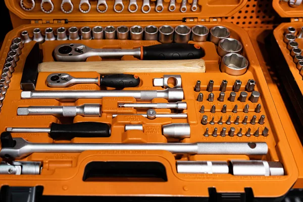 Box with special tools in car repair shop, closeup, selective focus - image