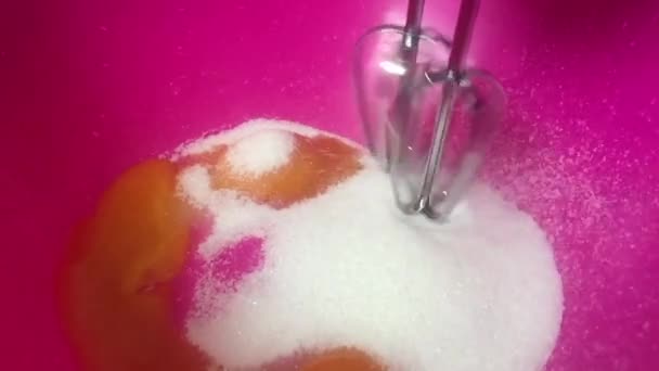 Slam egg yolk with mechanical whisk seen in slow motion with sugar — Stock Video