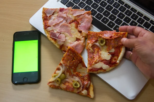 sliced Stuffed Italian pizza on a computer keyboard