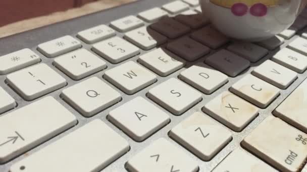 Taza de café derramado en un teclado portátil — Vídeos de Stock