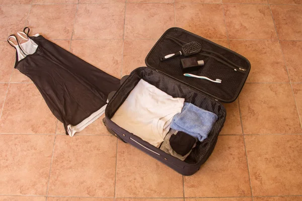 Mixed Clothing Entering Travel Suitcase — Stock Photo, Image