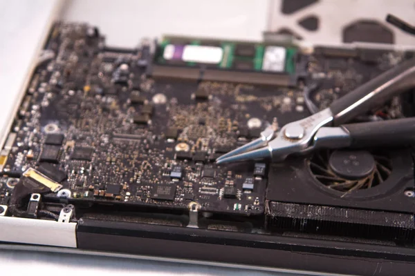 fixing a hard disk drive with one hand with gloves and a special tweezers