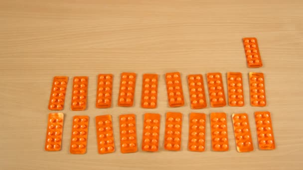 Stop motion time lapse of several blister packs with pilulky capsules appear along with euro banknotes on a table — Stock video