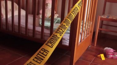 Bir motelde çocukların kaçırılması ile ilgili yan adli soruşturmalar. Deliller, ceket ve kukla gibi kanıtları olan dedektiflerin sarı kartlarıyla işaretlenmiş.