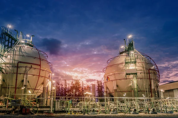 Gas storage sphere tanks and pipeline in oil and gas refinery industrial plant with sunset sky background