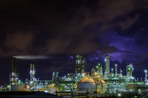 Glitter lighting of petrochemical industrial plant at night, Manufacturing of petroleum industry, Oil and gas refinery industrial plant on night sky background