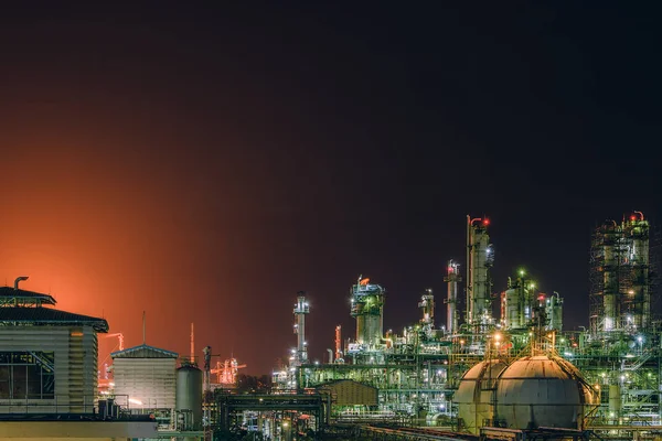 Glitter lighting of petrochemical plant at night, Manufacturing of petroleum industrial plant