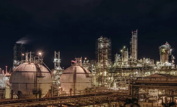 Gas storage sphere tanks in petroleum industrial plant at night, Glitter lighting of oil and gas refinery plant, Petrochemical industry