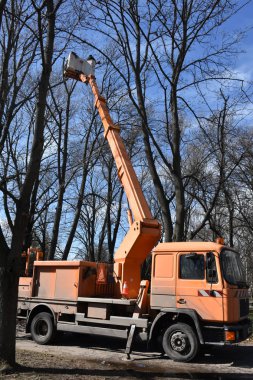 Day time shot of crane with a truck in city park