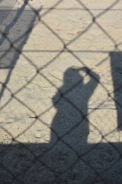 shadow of a man on the asphalt,