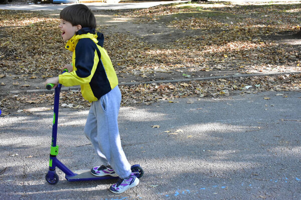 child and scooter in the park